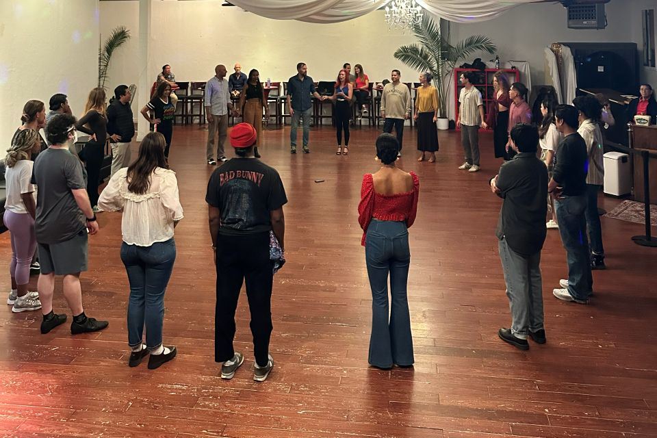 Dancers gathered in a circle during a class at Queen Bee's in North Park