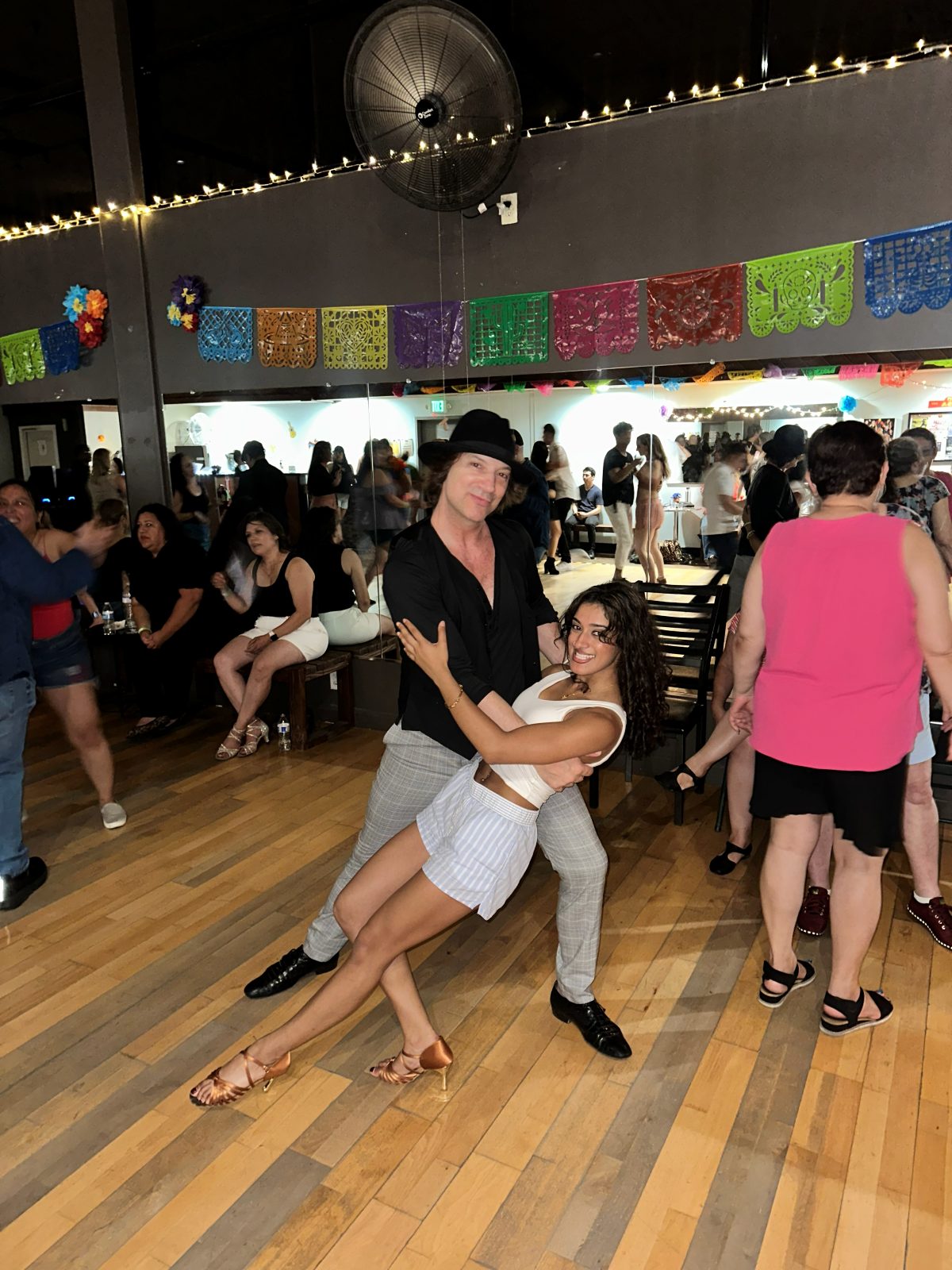 Anjali and Michael, founders of Positive Energy Dance Company, dancing at a studio social